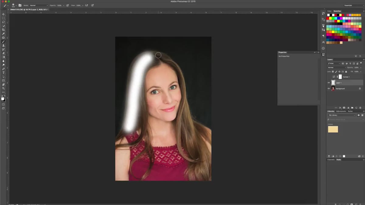 White brush strokes being painted along hair against dark background