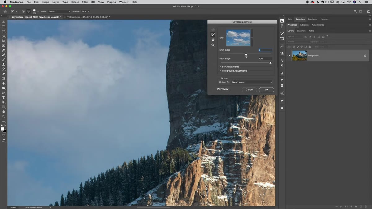 Sky Replacement brush tool active over tree line edge