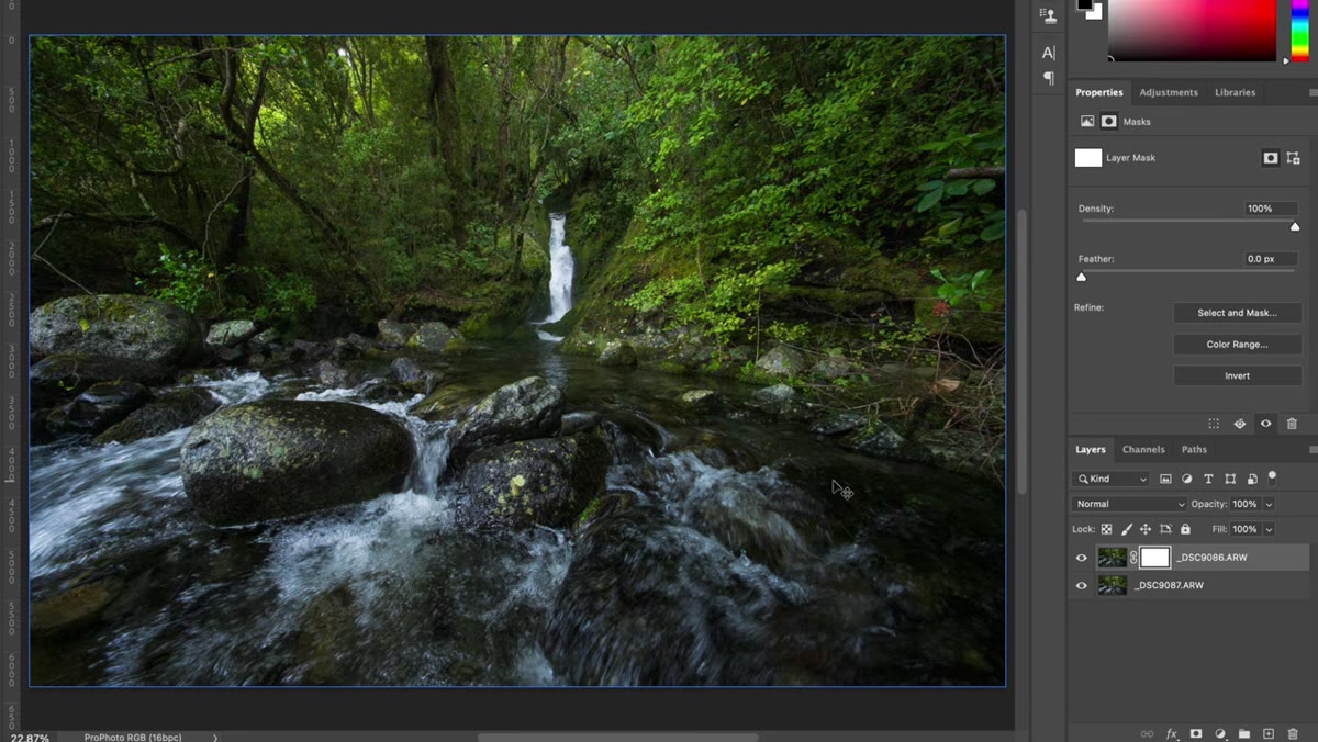 Black brush being painted over the waterfall area on the layer mask