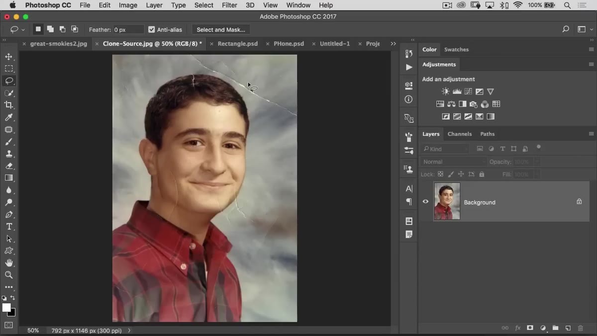 Lasso tool drawn loosely around a tear or blemish in the image